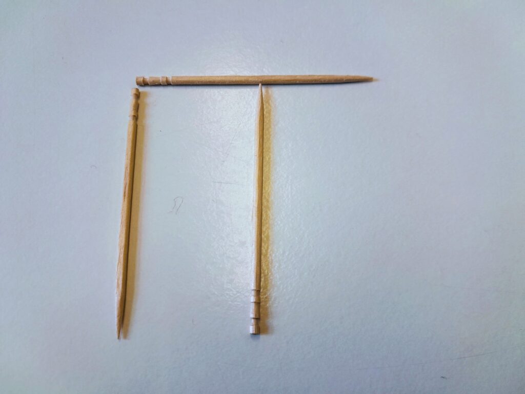 As previous image but the right hand toothpick has been moved across to the middle